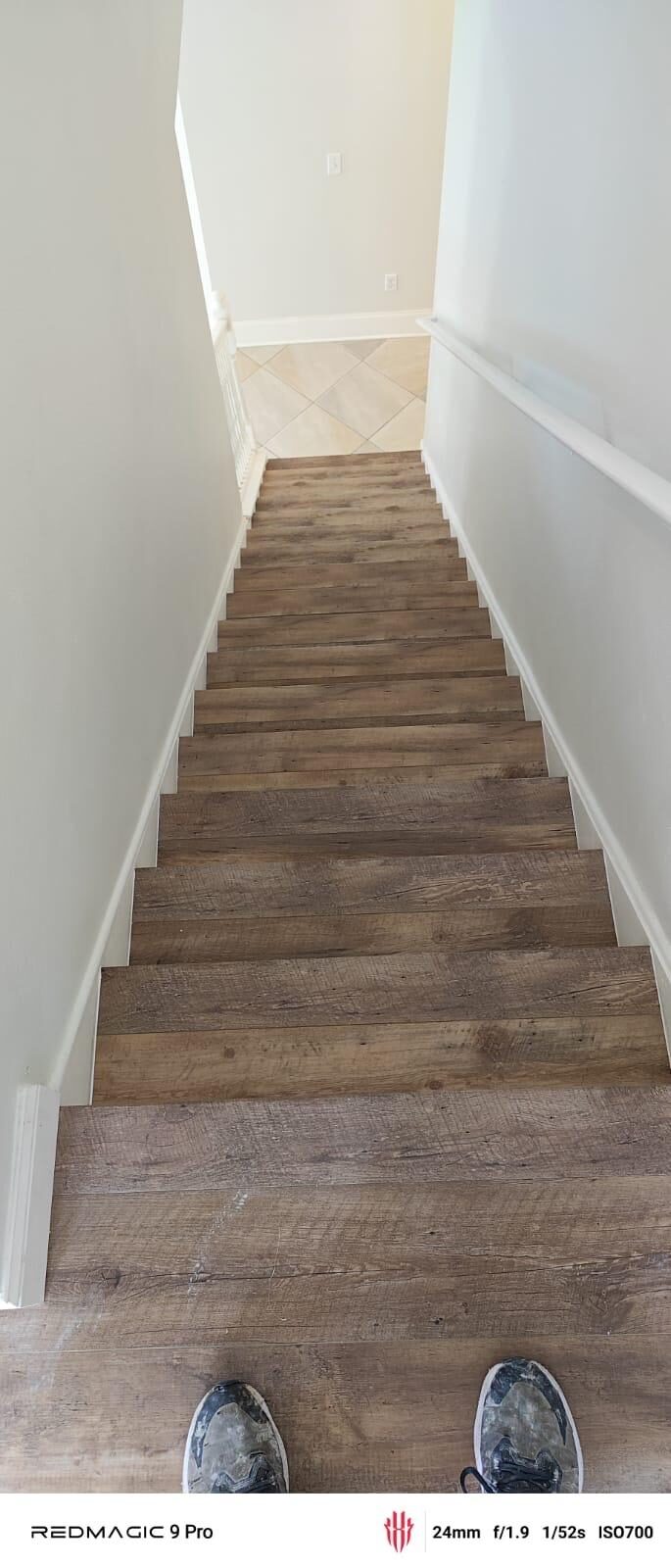 Looking down a newly installed wood-look tile staircase