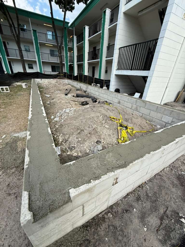 Exterior shot of a new concrete block wall perimeter for a garden or planter