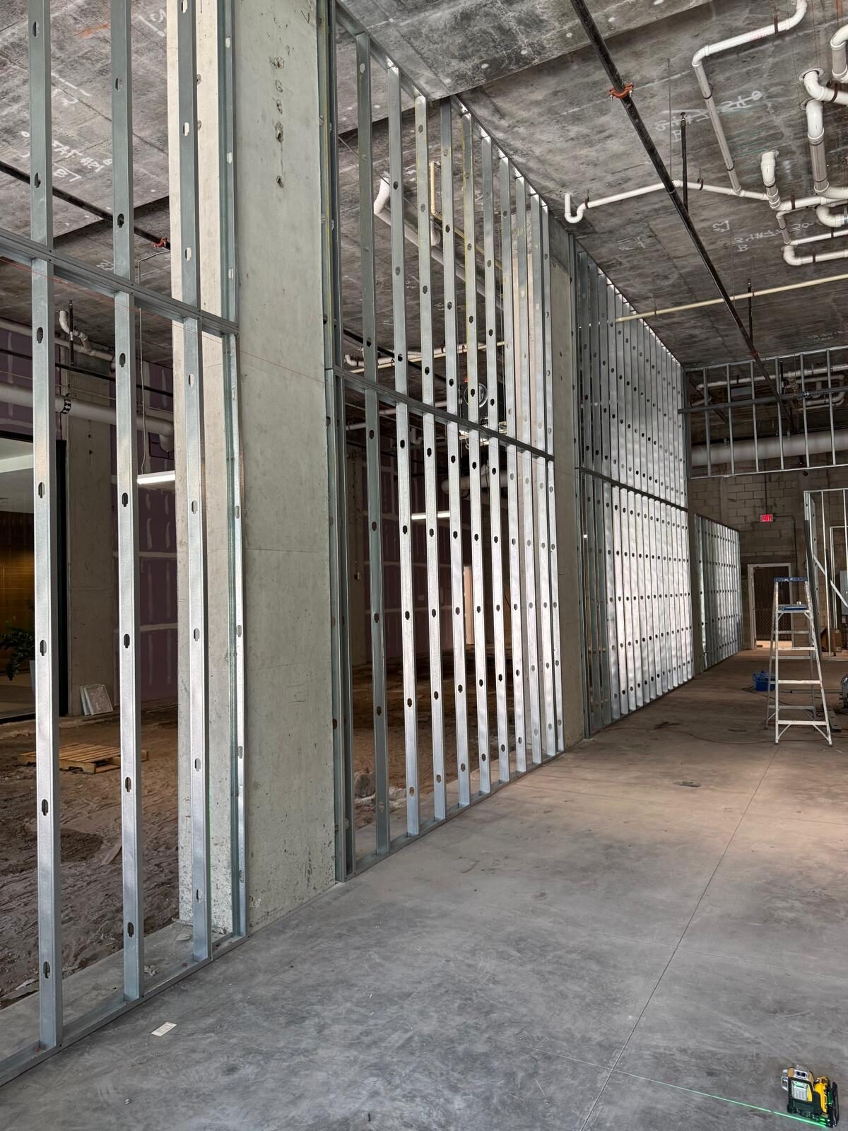 Interior view of commercial space with new metal stud framing for walls