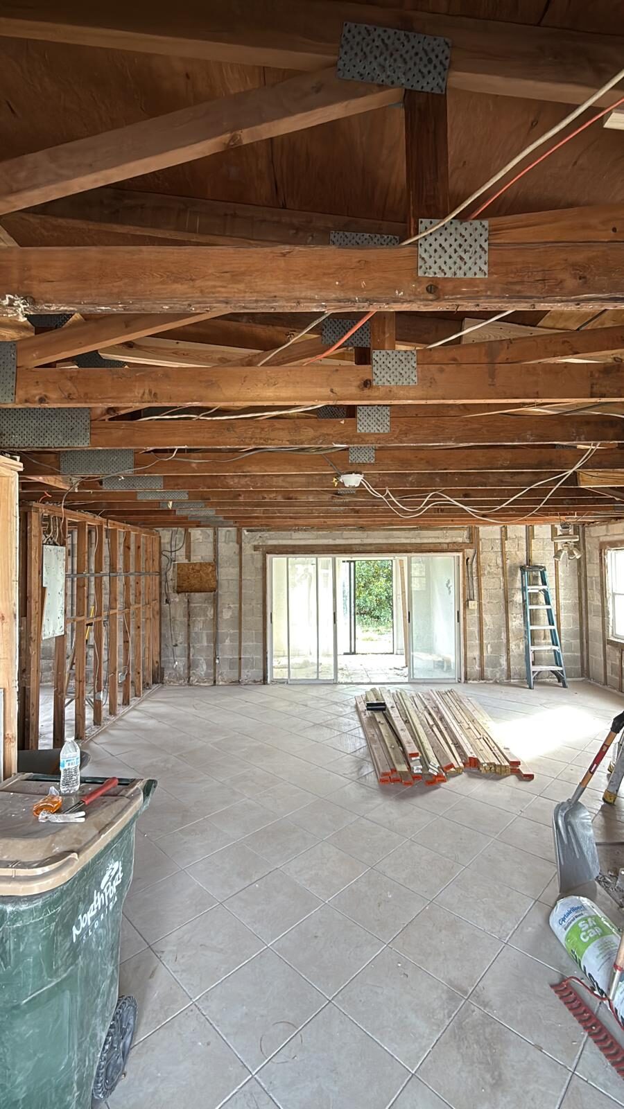 Exposed ceiling joists and wall studs in a home during renovation