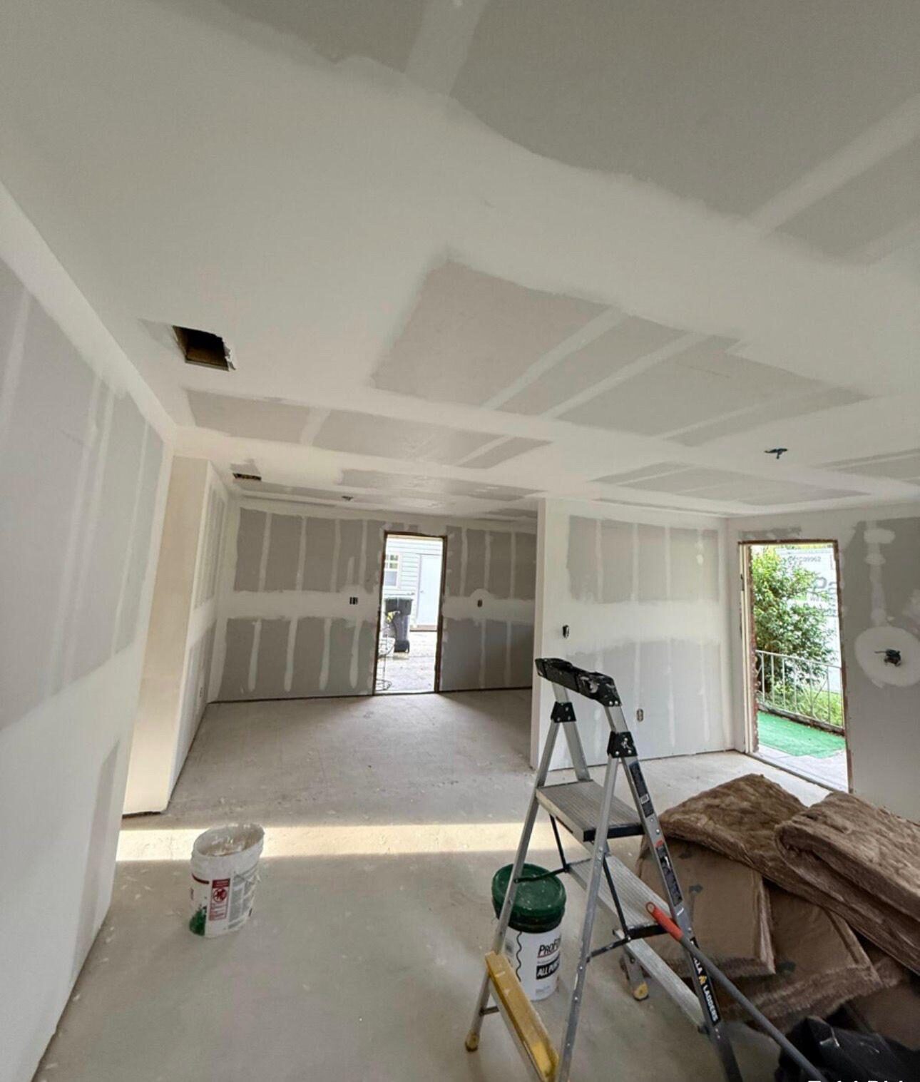 Interior room with new drywall installed, seams taped, and ready for mudding