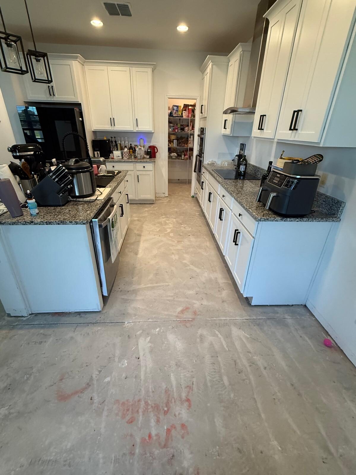 Modern remodeled residential kitchen with white cabinets and granite countertops in Tampa, FL